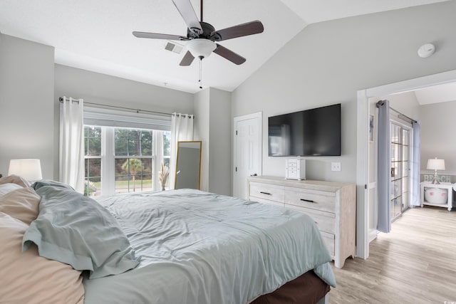 bedroom with lofted ceiling, light wood-type flooring, visible vents, and a ceiling fan