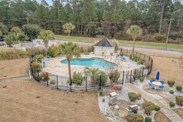 pool featuring a patio area and fence