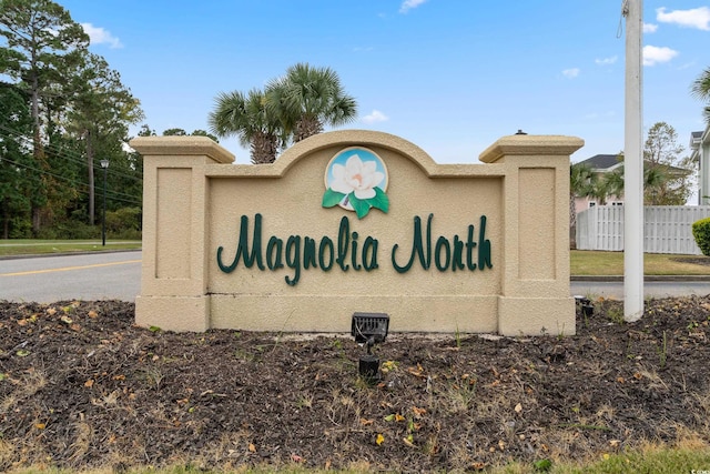 community / neighborhood sign with fence