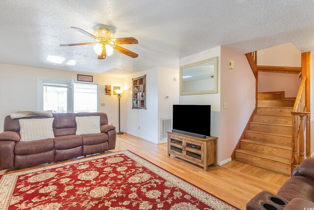 317 14th Ave N, Surfside Beach, SC 29575 - living area with a textured ceiling, ceiling fan, stairway, and light wood finished floors