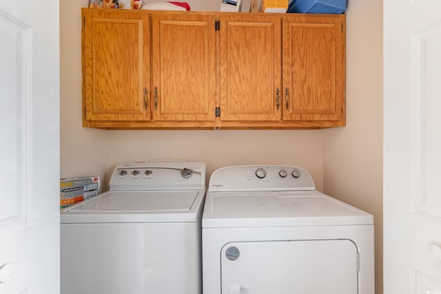 laundry area with cabinet space and washer and clothes dryer