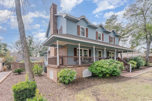 farmhouse with a porch and a chimney