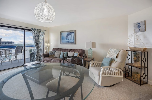 carpeted living room featuring a chandelier and a city view