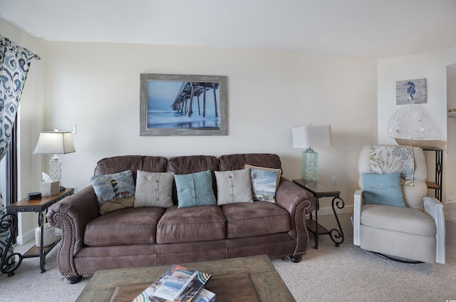 living room featuring baseboards and light colored carpet