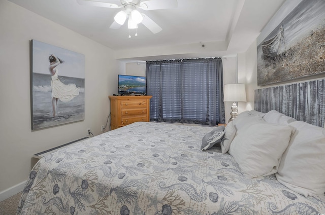 bedroom with a ceiling fan and baseboards