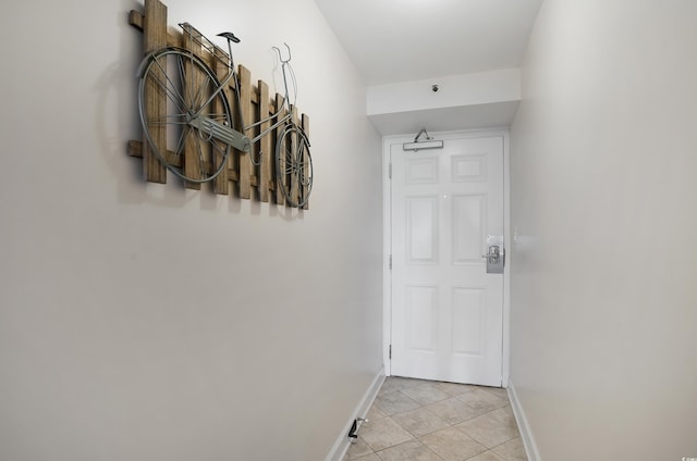 entryway with light tile patterned floors and baseboards