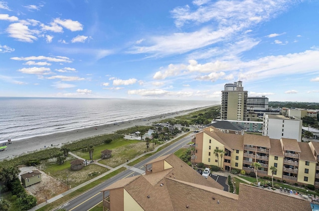 birds eye view of property featuring a water view and a beach view