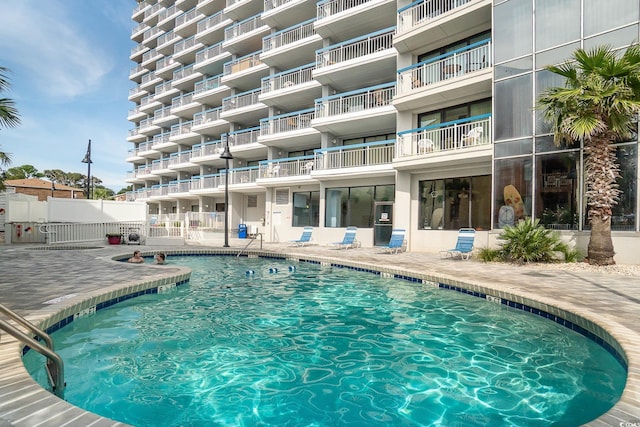 view of swimming pool with a patio area and fence