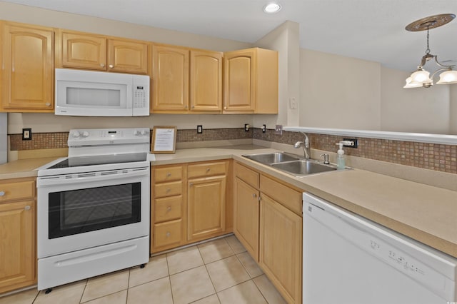 kitchen featuring light tile patterned floors, light countertops, light brown cabinets, a sink, and white appliances