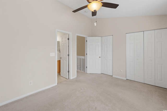 unfurnished bedroom with multiple closets, carpet, baseboards, and a ceiling fan