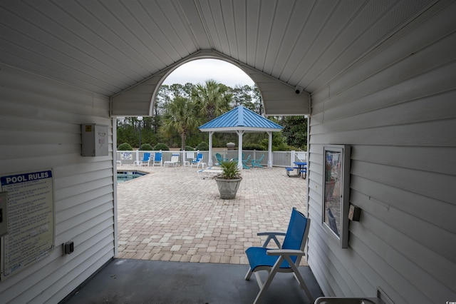 view of patio / terrace featuring fence and a community pool