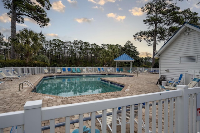 community pool featuring a patio area and fence