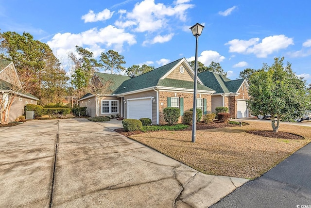 view of front of home with a garage, concrete driveway, brick siding, and central air condition unit