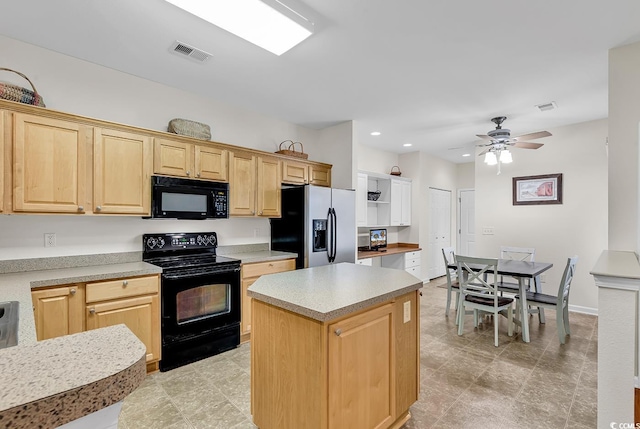 kitchen featuring black appliances, light brown cabinetry, light countertops, and visible vents