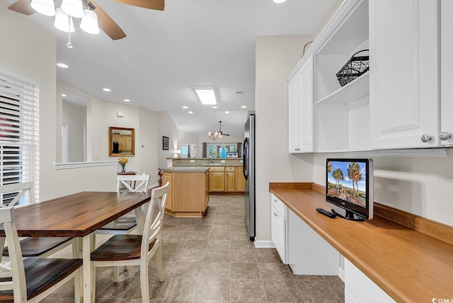 kitchen with a center island, open shelves, recessed lighting, freestanding refrigerator, and ceiling fan