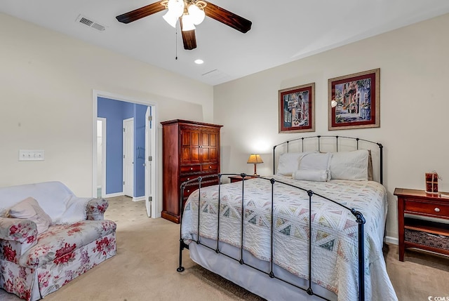 bedroom with light carpet, ceiling fan, visible vents, and baseboards