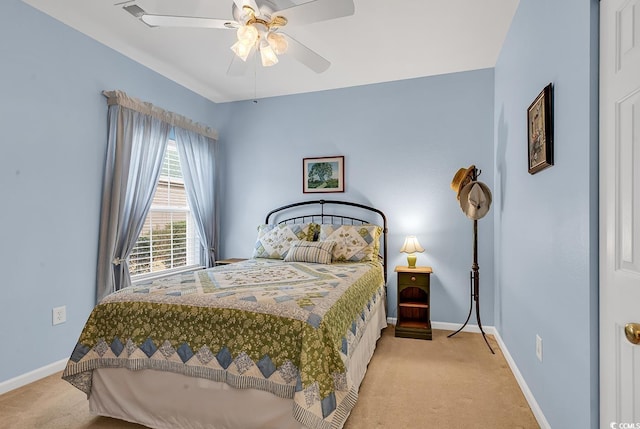 carpeted bedroom with ceiling fan and baseboards