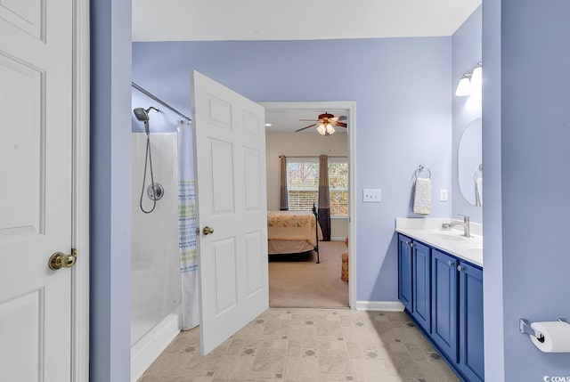 bathroom with curtained shower, connected bathroom, vanity, baseboards, and a ceiling fan