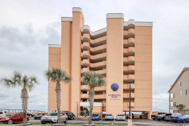 view of building exterior with uncovered parking