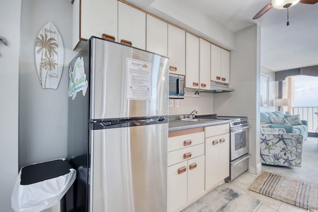 kitchen with ceiling fan, under cabinet range hood, white cabinetry, light countertops, and appliances with stainless steel finishes