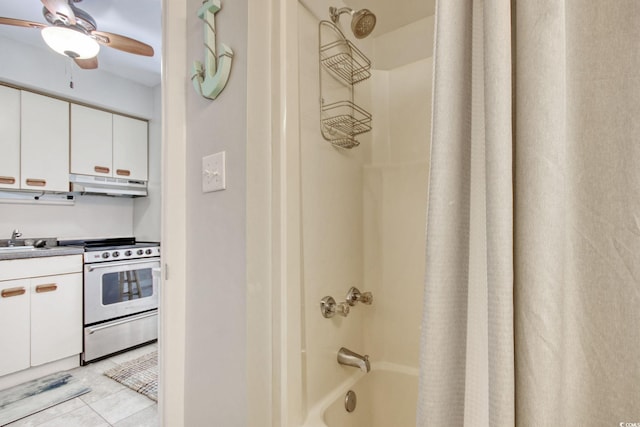 full bathroom with tile patterned flooring, ceiling fan, vanity, and shower / bath combo with shower curtain