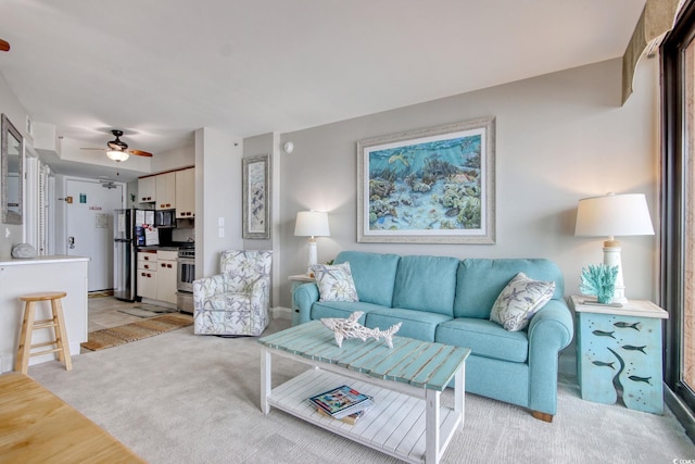 living room with light carpet and ceiling fan