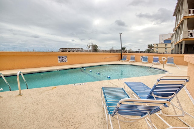 community pool with a patio area