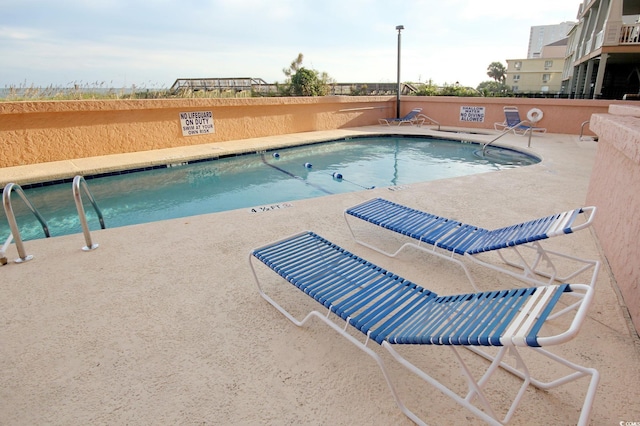 community pool with a patio area