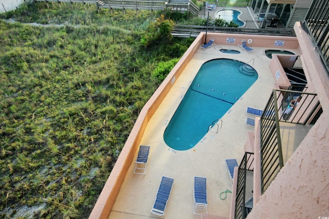 view of swimming pool featuring a community hot tub