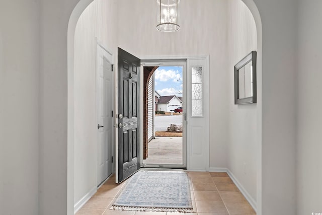 entryway featuring baseboards and arched walkways