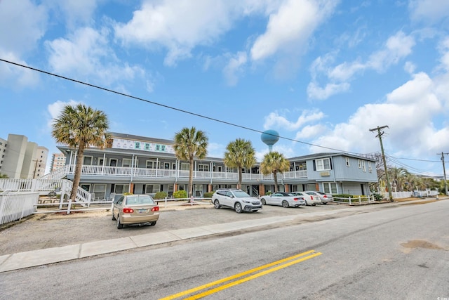 view of front of property with uncovered parking and stairs