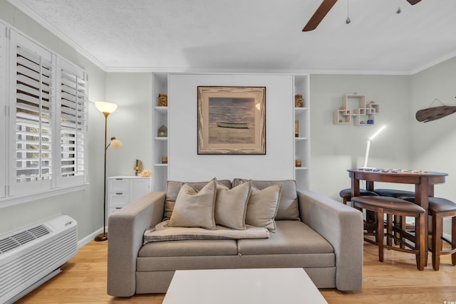 living area featuring light wood-type flooring, crown molding, a textured ceiling, and ceiling fan