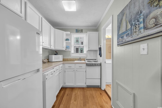 kitchen with open shelves, light countertops, ornamental molding, white cabinetry, and white appliances