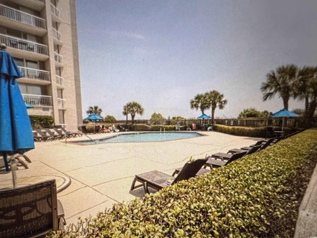 community pool featuring a patio area