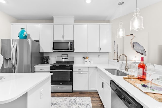 kitchen with a sink, stainless steel appliances, light countertops, and white cabinets