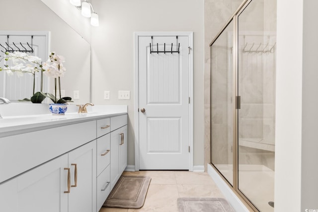 bathroom with a stall shower, tile patterned floors, and vanity