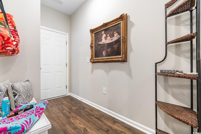 entrance foyer with dark wood-style floors and baseboards