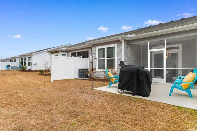 back of house with a lawn, a sunroom, a patio area, fence, and cooling unit