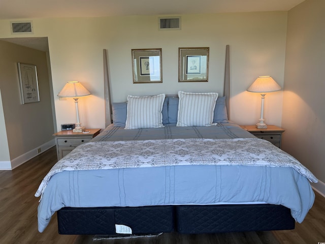 bedroom featuring dark wood-style flooring, visible vents, and baseboards