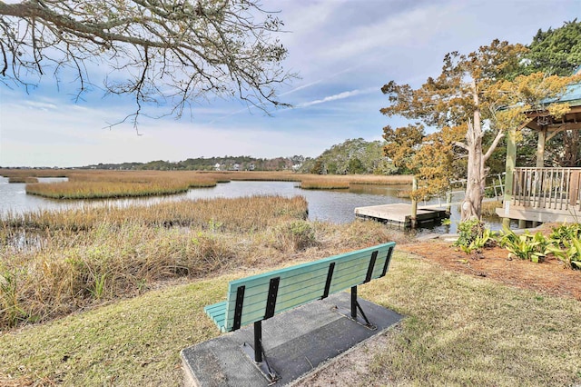 surrounding community with a water view and a floating dock