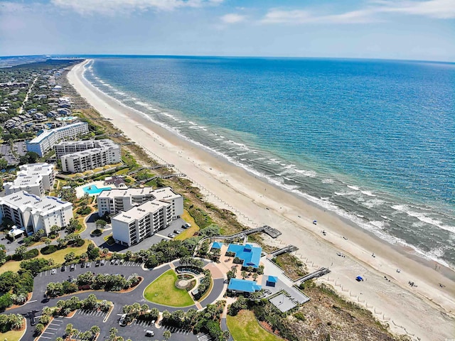 birds eye view of property featuring a water view and a beach view