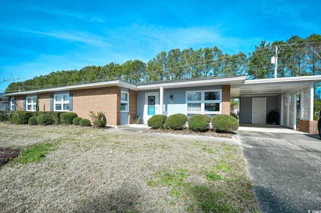 view of front of property with brick siding and driveway