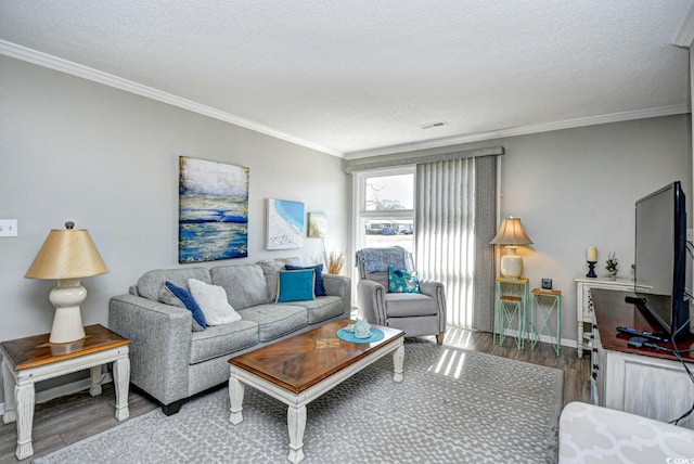 living area featuring a textured ceiling, wood finished floors, visible vents, and crown molding