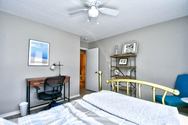 bedroom featuring dark wood-style floors, ceiling fan, a textured ceiling, and baseboards