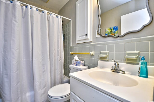 bathroom with tile walls, shower / tub combo with curtain, vanity, and toilet