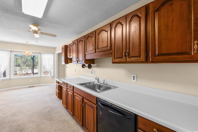 kitchen with a sink, brown cabinets, light countertops, and dishwasher