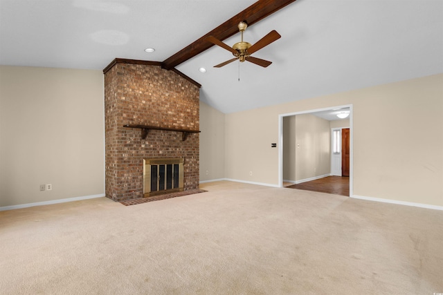 unfurnished living room featuring vaulted ceiling with beams, a brick fireplace, carpet, and baseboards