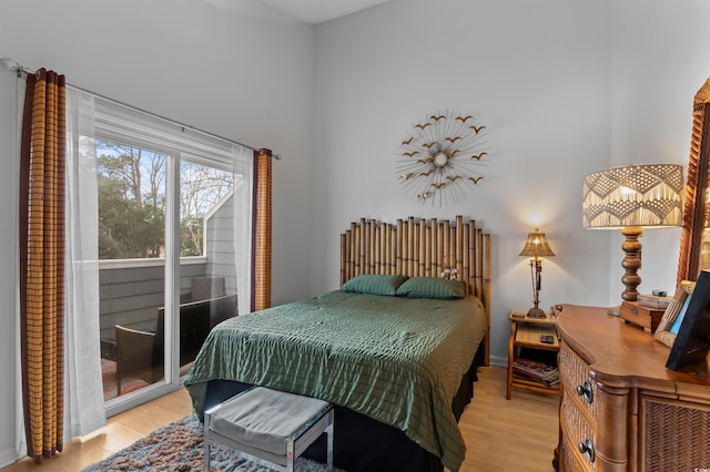 bedroom with light wood finished floors and access to exterior