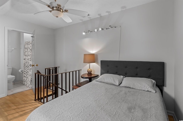 bedroom featuring connected bathroom and wood finished floors