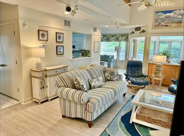 interior space with ceiling fan, visible vents, and light wood-style floors